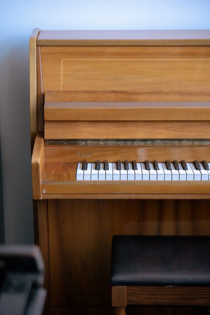 High angle of acoustic musical instrument made of wood placed near seat in music hall